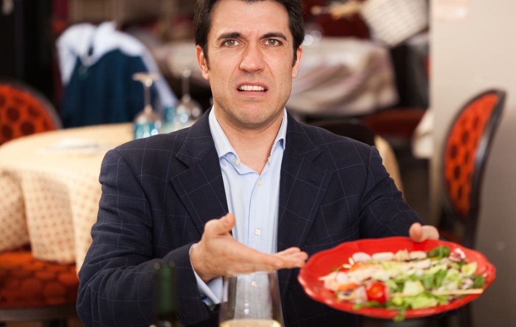 Restaurant owner reading fake negative review